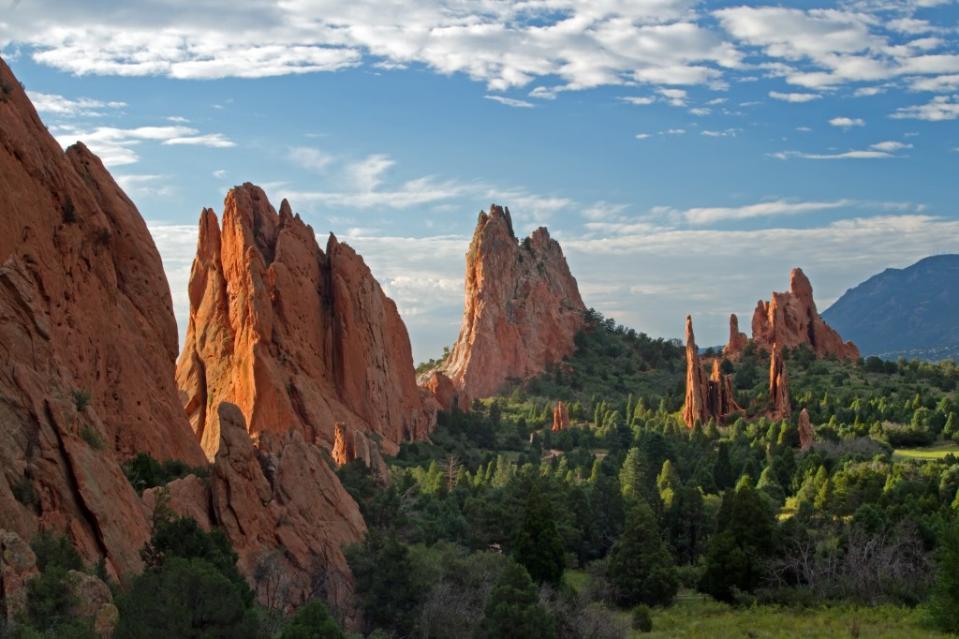 Blue skies with clouds over lookout view of Garden of the Gods via Getty Images