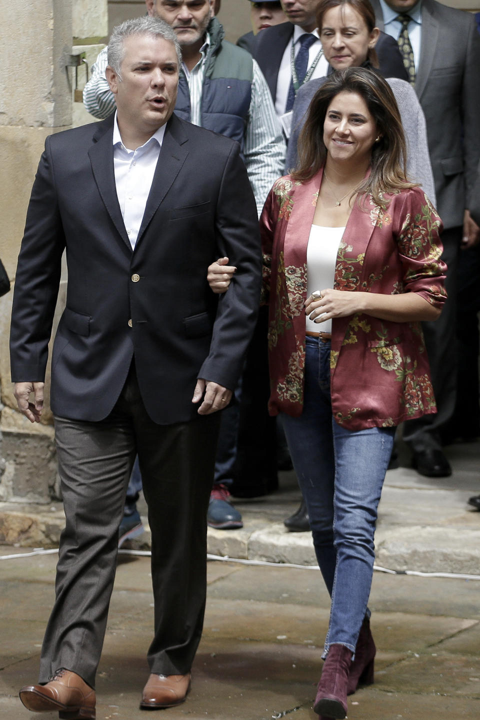 Colombia's President Ivan Duque arrives with his wife Maria Juliana Ruiz to cast his ballot during a nationwide referendum that seeks to curb corruption in Bogota, Colombia, Sunday, Aug. 26, 2018. Voters were asked to approve seven proposals that referendum supporters hope will bring about tougher anti-corruption legislation. (AP Photo/Ivan Valencia)
