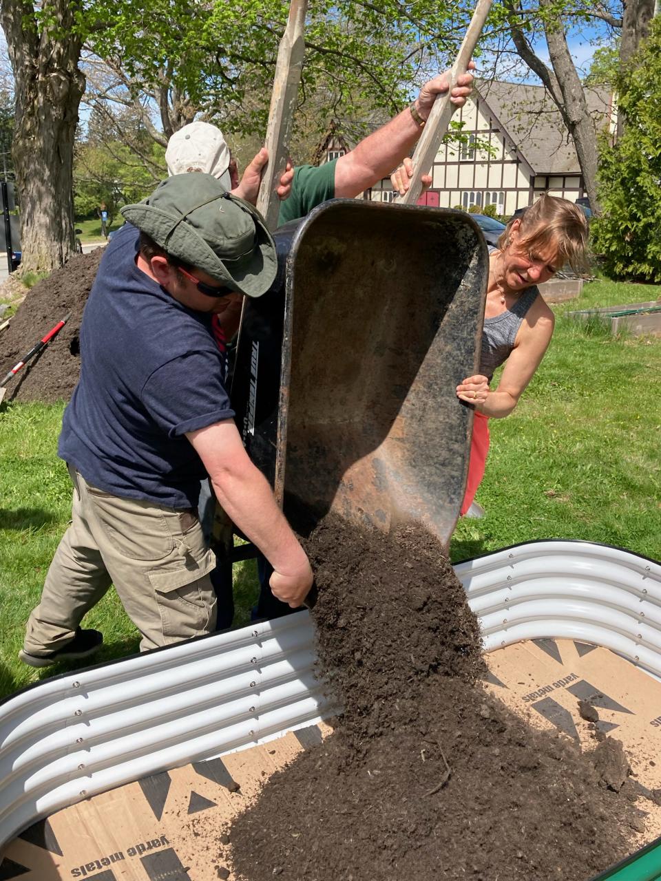 Brandon Grenier, left, Bill Grenier and Jenny Crellin recently volunteered to help plant a community garden at St. Paul's Episcopal Church in Gardner.