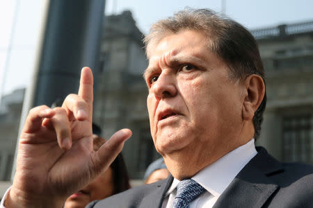 FILE PHOTO: Former Peruvian President Alan Garcia talks to the media as he arrives at the National Prosecution office in Lima, Peru March 27, 2018. REUTERS/Guadalupe Pardo/File Photo