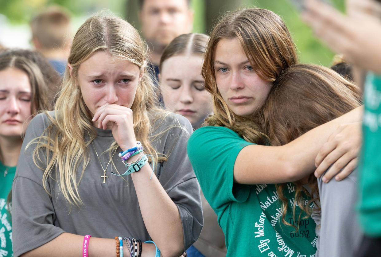 Girl Scout troop members remember the Dunham family at a vigil Saturday night for the family at Hartville Memorial Park.