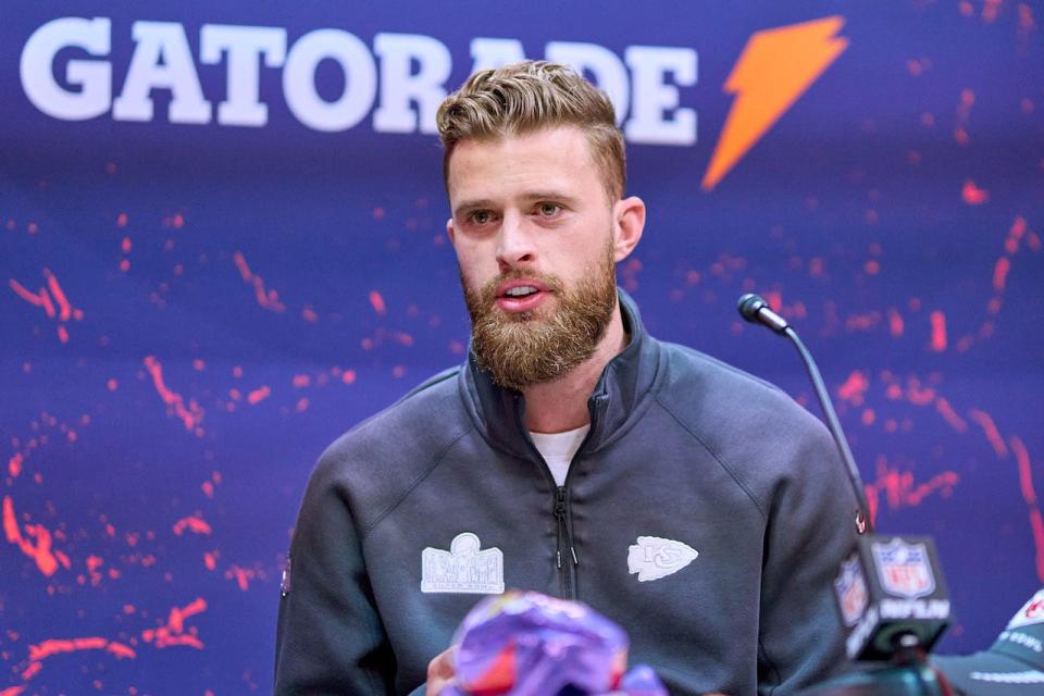 NFL player Harrison Butker sits in front of a microphone during the Super Bowl LVIII opening night.