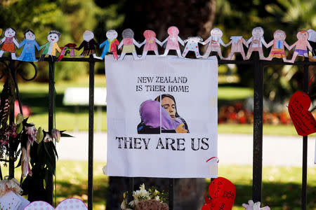 A poster hangs at a memorial site for victims of Friday's shooting, in front of Christchurch Botanic Gardens in Christchurch, New Zealand March 19, 2019. REUTERS/Jorge Silva