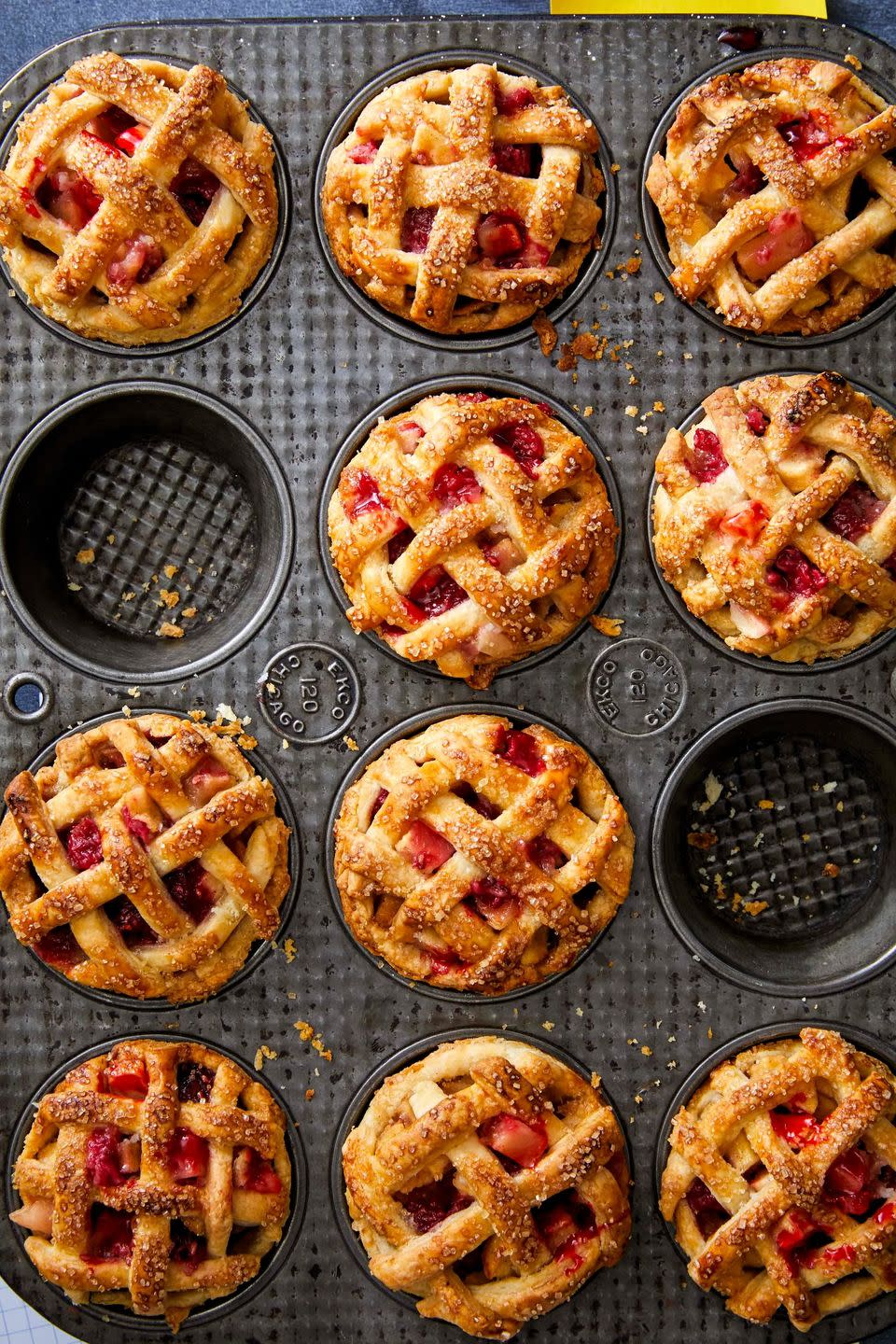 mini apple and raspberry pies in a muffin tin