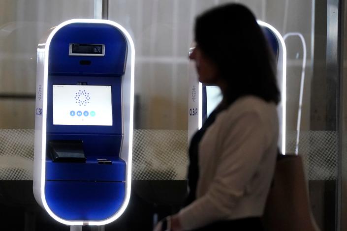 Travelers pass through transparent kiosks in the domestic terminal of San Francisco International Airport in San Francisco, Friday, May 26, 2023.