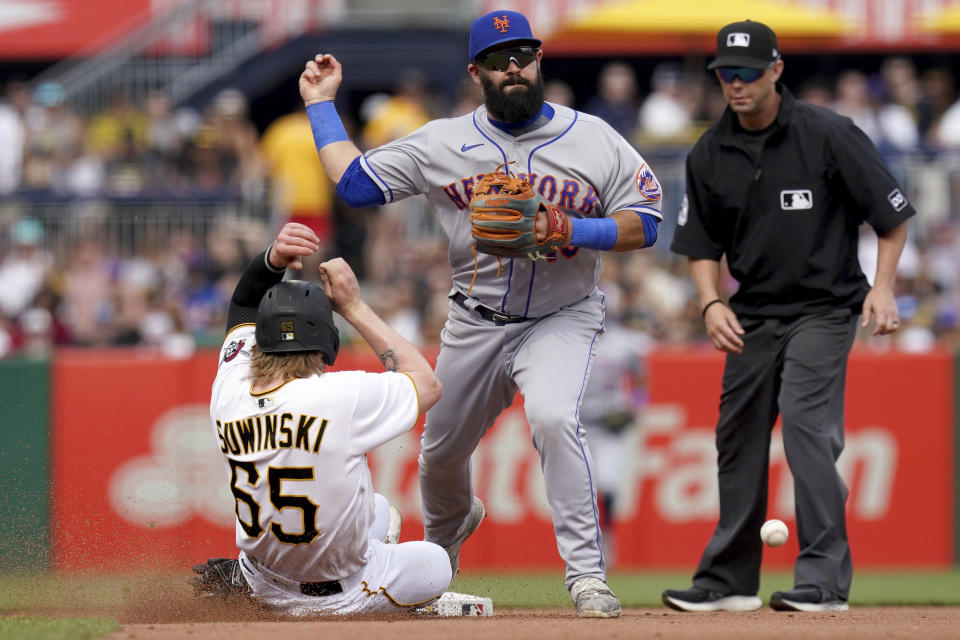 Pittsburgh Pirates' Jack Suwinski slides into second base safely as New York Mets shortstop Luis Guillorme is unable to make the throw to first in the fourth inning in a baseball game in Pittsburgh, Saturday, June 10, 2023. Guillorme was charged with an error on the play. (AP Photo/Matt Freed)