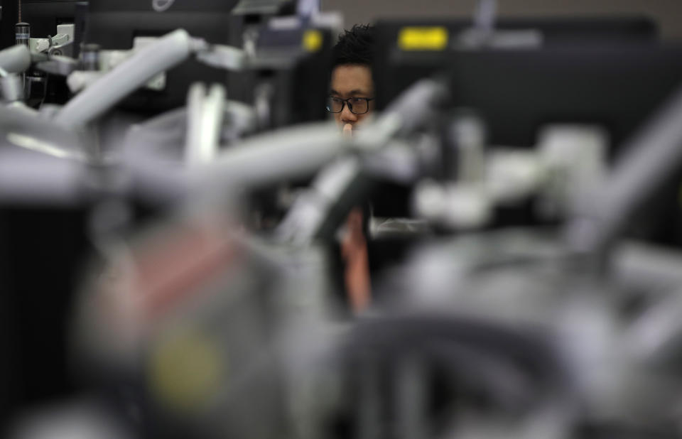 A currency trader watches computer monitors at the foreign exchange dealing room in Seoul, South Korea, Thursday, June 4, 2020. Asian stock markets are mixed after Wall Street rose on better U.S. jobs and manufacturing data than expected. (AP Photo/Lee Jin-man)