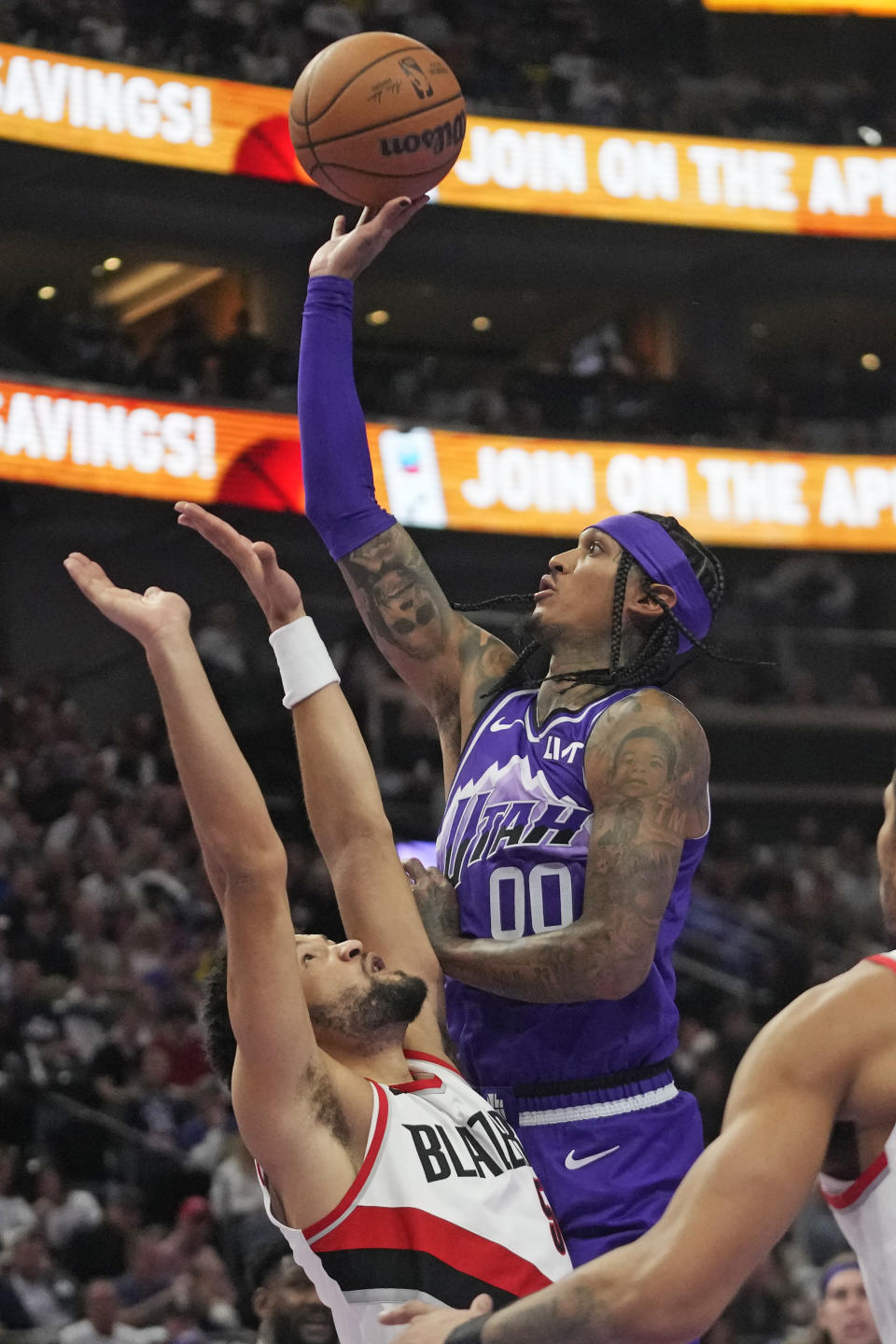 Utah Jazz guard Jordan Clarkson (00) shoots as Portland Trail Blazers guard Skylar Mays, left, defends during the second half of an NBA basketball in-season tournament game, Tuesday, Nov. 14, 2023, in Salt Lake City. (AP Photo/Rick Bowmer)