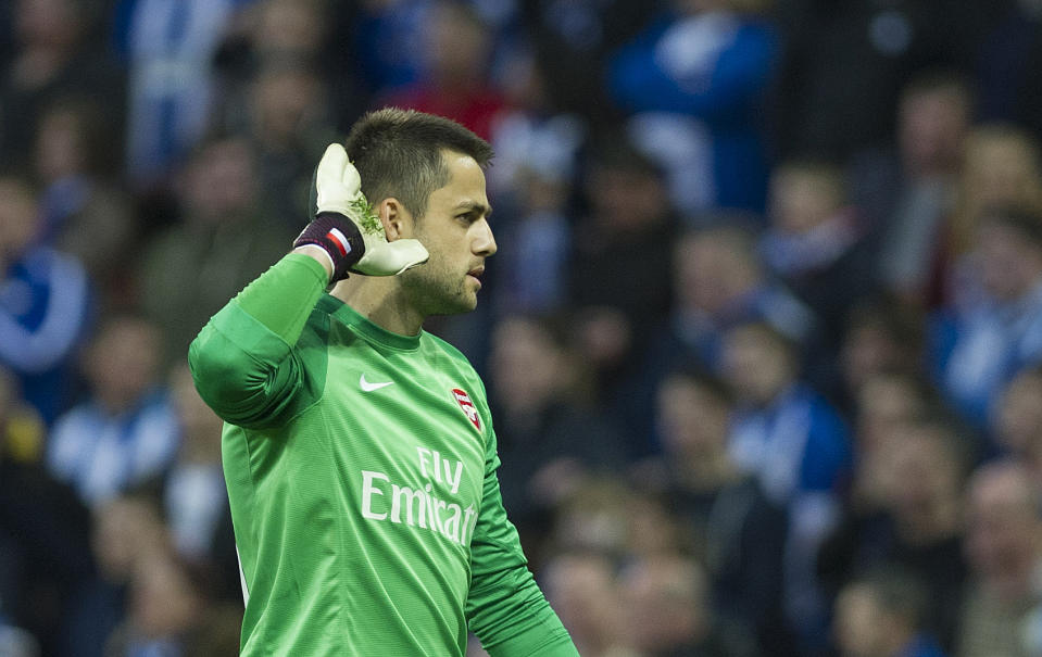 Arsenal's Lukasz Fabianski, reacts during their English FA Cup semifinal soccer match against Wigan Athletic, at the Wembley Stadium in London, Saturday, April 12, 2014. (AP Photo/Bogdan Maran)