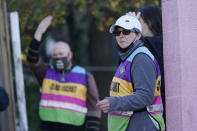 Pink House Defenders signal patients to drive onto the clinic parking lot at the Jackson Women's Health Organization, a state-licensed abortion facility in Jackson, Miss., Wednesday, Dec. 1, 2021. A small group of anti-abortion activists stood outside the clinic in an effort to dissuade patients from entering, the escorts attempt to shield them from the anti-abortion activists. On Wednesday, the U.S. Supreme Court hears a case that directly challenges the constitutional right to an abortion established nearly 50 years ago. (AP Photo/Rogelio V. Solis)