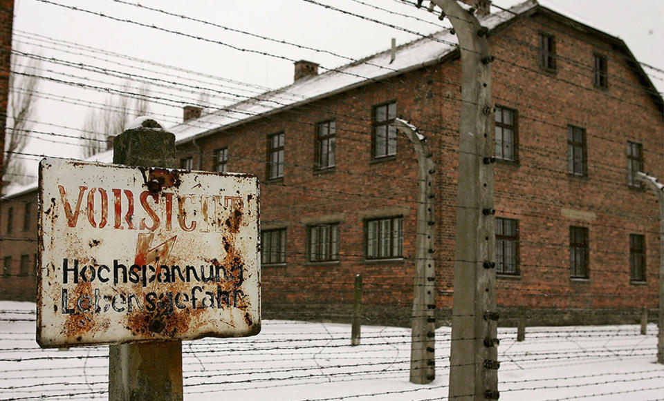 A warning sign is seen beside a fence at the Auschwitz Concentration Camp. Source: Julian Herbert/Getty Images