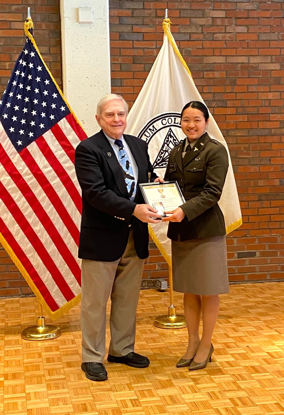 Frank Lennon presents the Military Order of Foreign Wars Award for Academic Excellence to Brown University's Rachel Huynh at the annual awards ceremony for the Providence College Patriot Battalion on April 7.