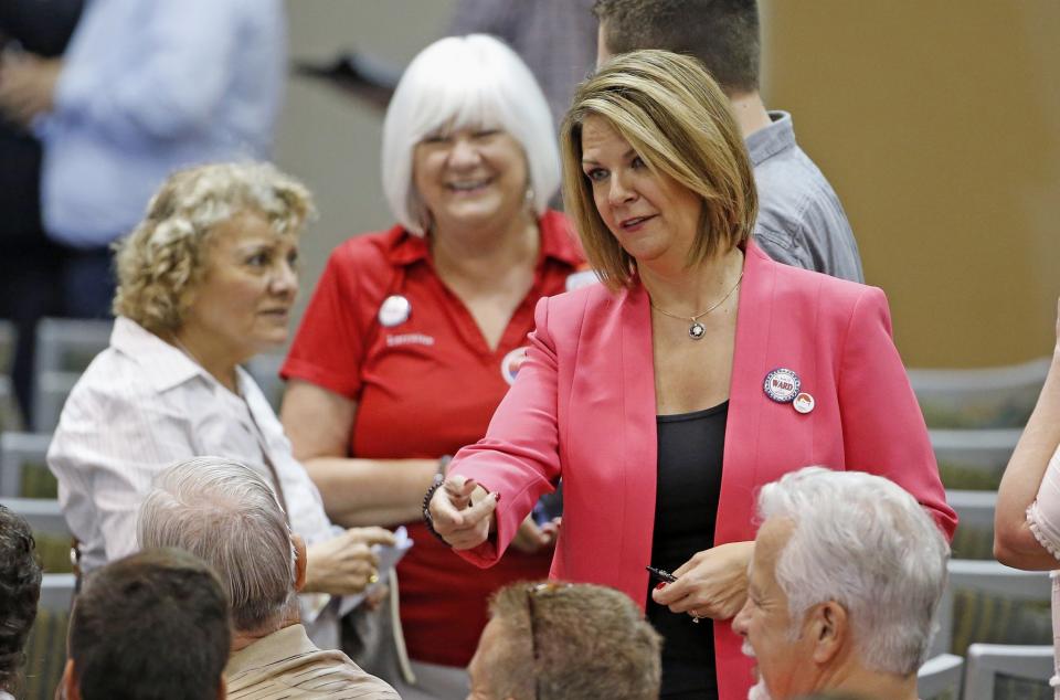 Kelli Ward, right, who is running against Sen. John McCain in the Arizona Republican primary, talks to voters. (Photo: Ross D. Franklin/AP)