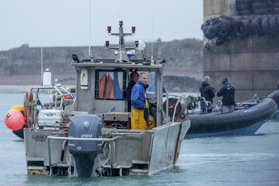 A French fishing vessel blocks the port of St Helier in Jersey, Thursday, May 6, 2021. French fishermen angry over loss of access to waters off their coast have gathered their boats in protest off the English Channel island of Jersey. The head of a grouping of Normandy fishermen said about 50 boats from French ports joined the protest Thursday morning and gathered their fleet off the Jersey port of St. Helier. (Gary Grimshaw/Balliwick Express via AP)