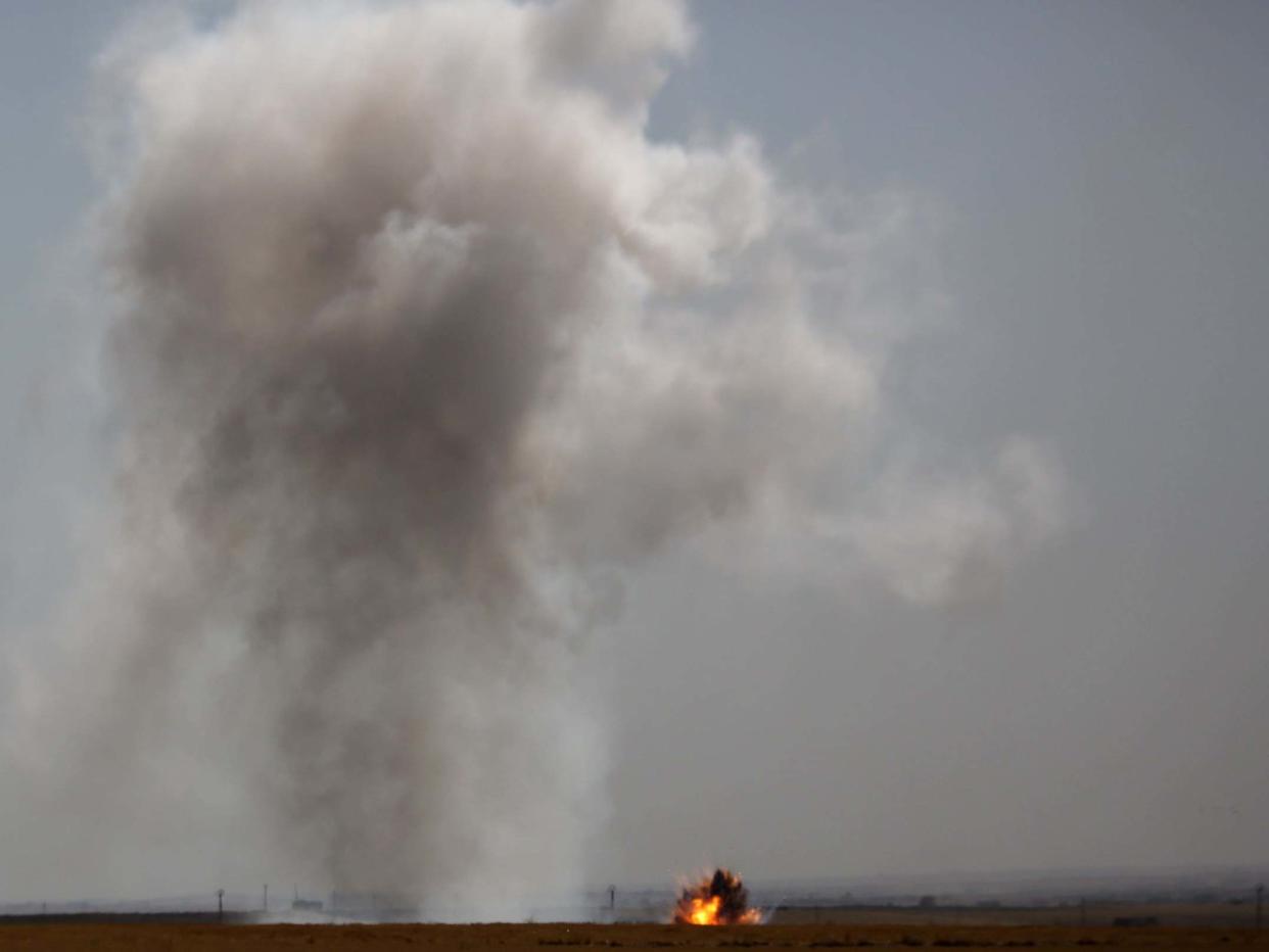 Smoke billows from the Syrian border town of Tal Abyad on October 12, 2019: AFP via Getty Images
