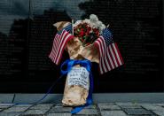 Flowers draped in flags have been left at Vietnam Veterans Memorial on U.S. Memorial Day holiday in Washington