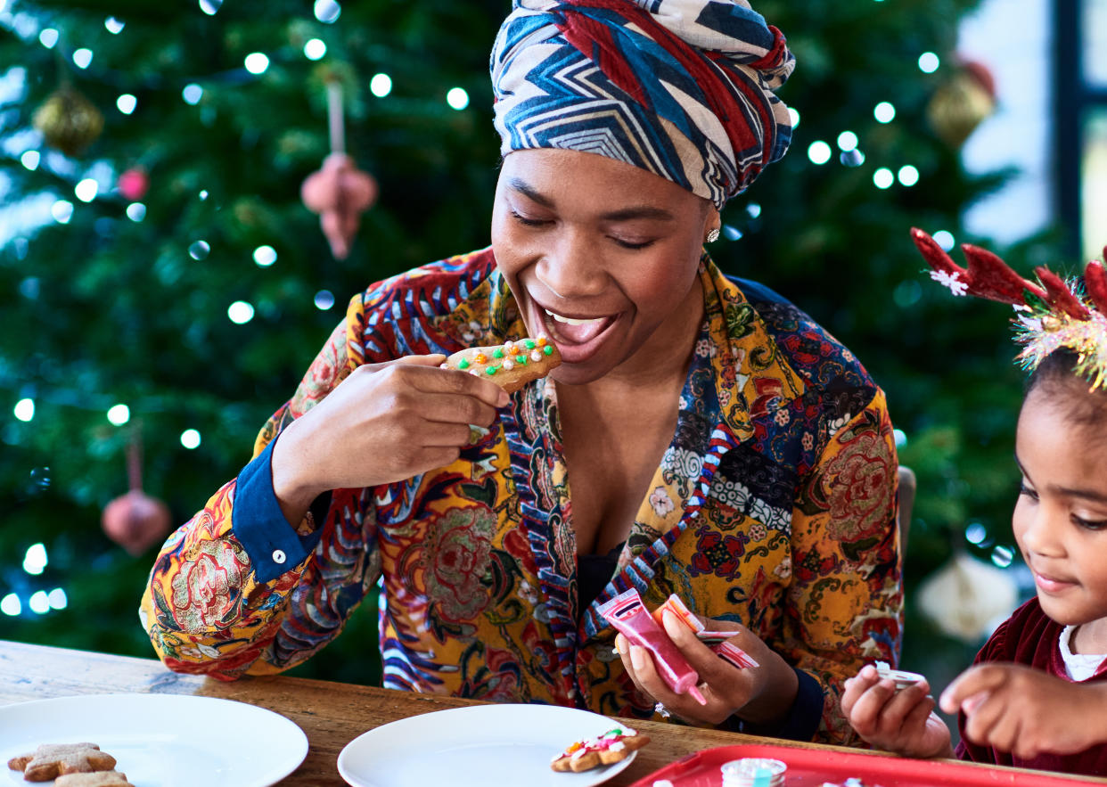 Mother and daughter eating cookies. Hormone health Christmas. (Getty Images)