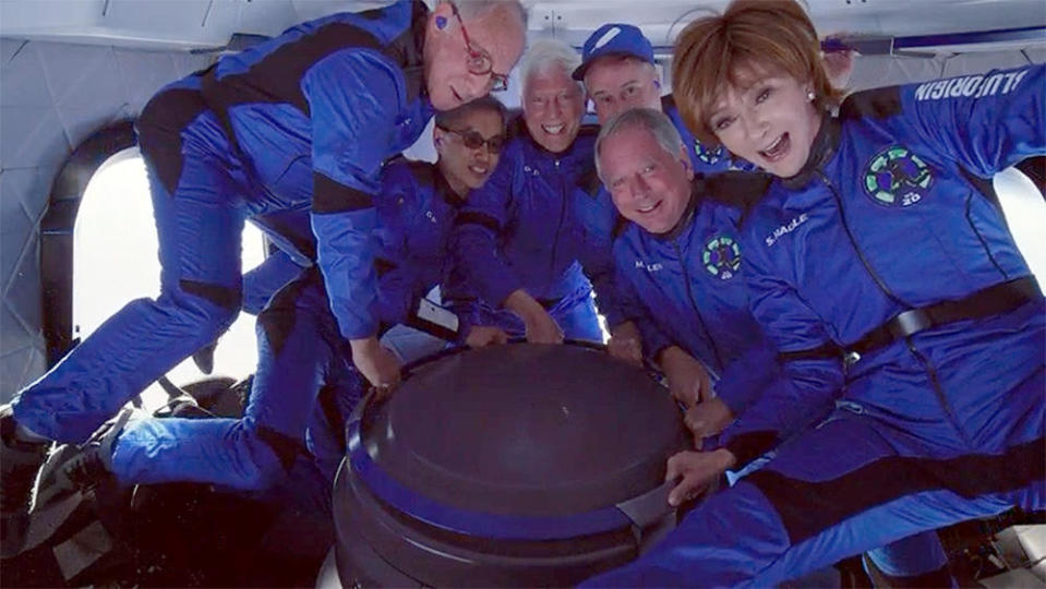 The New Shepard crew poses in zero gravity (left to right): Marc Hagle, Gary Lai, George Nield, Jim Kitchen, Marty Allen and Sharon Hagle. / Credit: Blue Origin