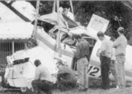 Investigators examine a plane that crashed on June 19, 2002 just after takeoff from the Naples Municipal Airport.
