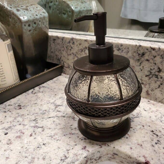 the round soap dispenser on a bathroom counter