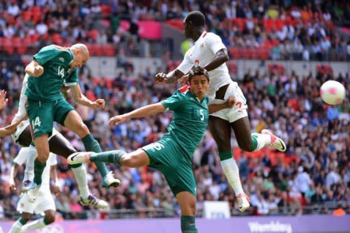 Senegal's forward Moussa Konate (R) challenges Mexico's midfielder Jorge Enriquez (L) and defender Darvin Chavez (C) for the ball in their Olympic quarter-final at Wembley Stadium in London. Mexico won 4-2