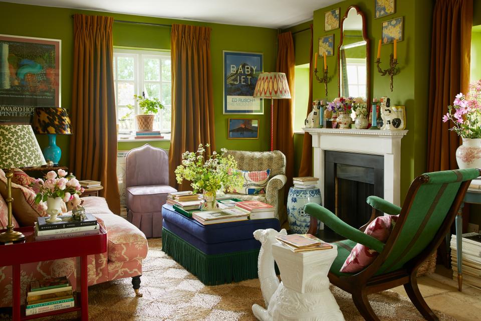 The living room is painted with a Leyland green; Campbell designed the lilac slipper chair.