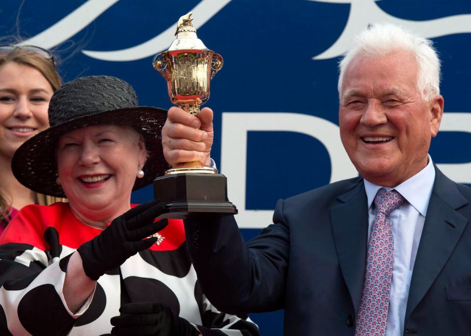 Owner Frank Stronach is presented with the trophy by Lieutenant Governor of Ontario Elizabeth Dowdeswell after Shaman Ghost won the 156th running of the Queen's Plate at Woodbine Racetrack in Toronto on Sunday, July 5, 2015. THE CANADIAN PRESS/Frank Gunn