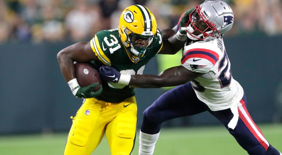 Green Bay Packers running back Emanuel Wilson (31) tries to get past <a class="link " href="https://sports.yahoo.com/nfl/teams/new-england/" data-i13n="sec:content-canvas;subsec:anchor_text;elm:context_link" data-ylk="slk:New England Patriots;sec:content-canvas;subsec:anchor_text;elm:context_link;itc:0">New England Patriots</a> safety Brad Hawkins (29) during their preseason football game Saturday, August 19, 2023, at Lambeau Field in Green Bay, Wis. Dan Powers/USA TODAY NETWORK-Wisconsin.