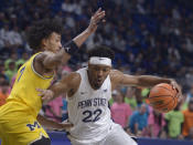 Penn State's Jalen Pickett (22) drives to the basket on Michigan's Kobe Bufkin during the first half of an NCAA college basketball game, Sunday, Jan. 29, 2023, in State College, Pa. (AP Photo/Gary M. Baranec)