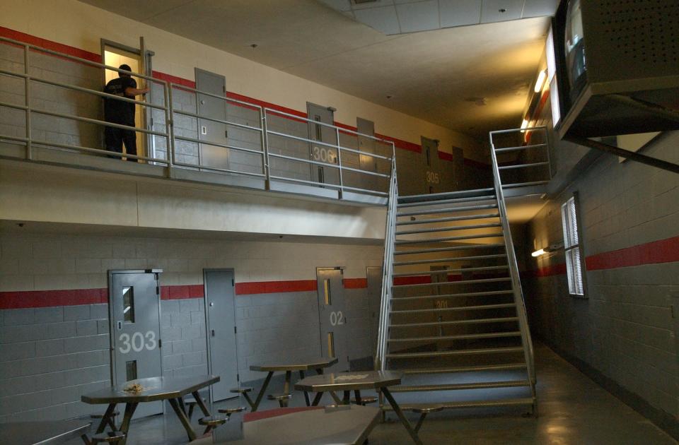 An interior photo shows metal stairs inside the Fulton County Jail.