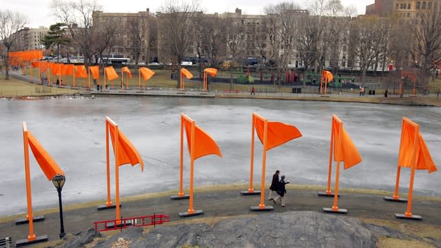 Pedestrians walk along the edge of Harlem Meer under The Gates project by artists Christo and Jeanne-Claude in New York’s Central Park