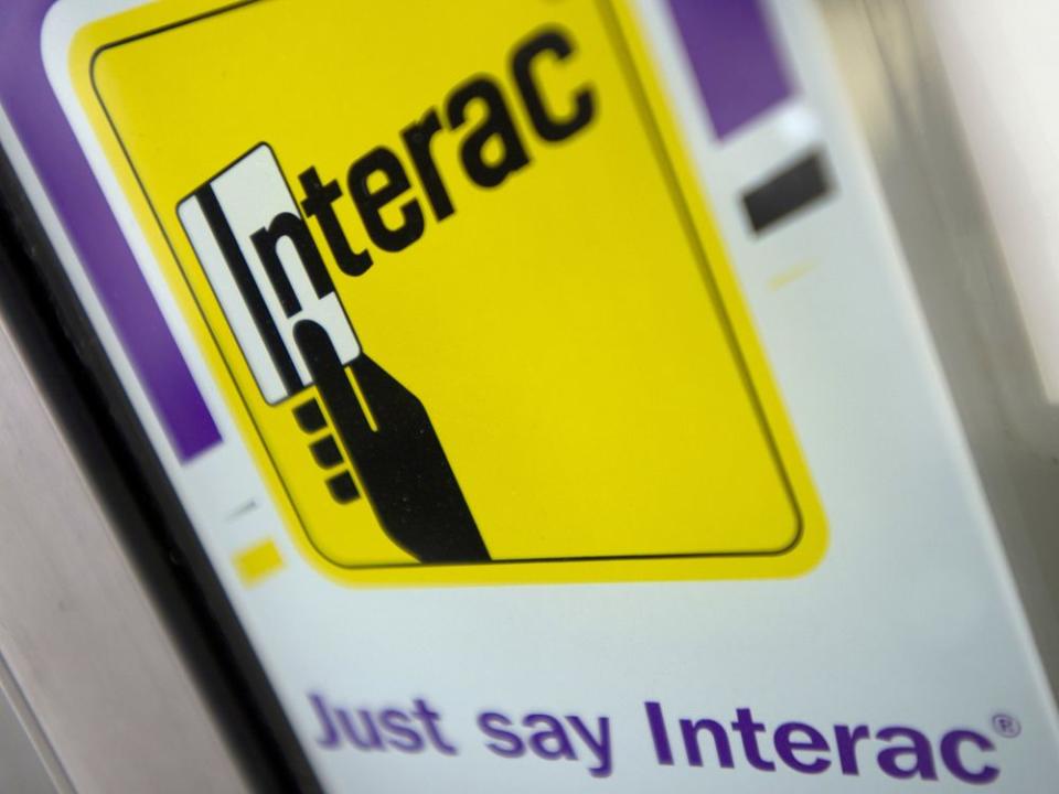  A Interac Corp. sign on a business storefront in North Vancouver, B.C.