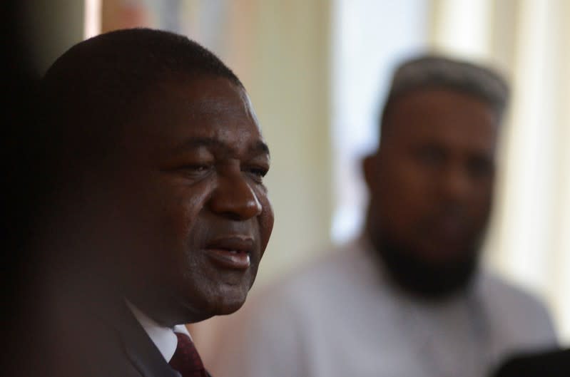 FILE PHOTO: Mozambique's President Filipe Nyusi speaks with the press after voting in Maputo