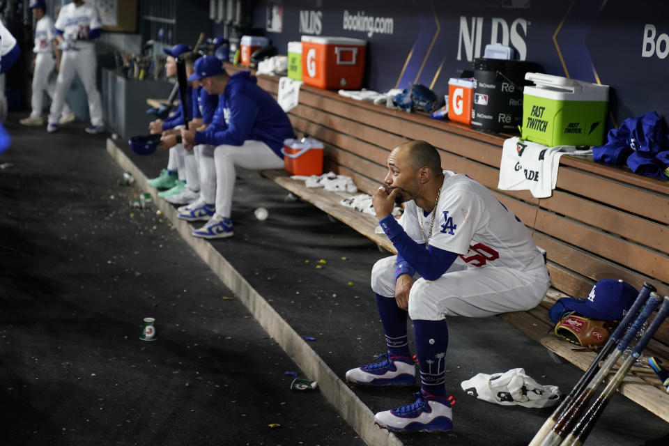 Los Angeles Dodgers second baseman Mookie Betts looks on from the dugout during the fifth inning in Game 1 of a baseball NL Division Series against the Arizona Diamondbacks, Saturday, Oct. 7, 2023, in Los Angeles. (AP Photo/Ashley Landis)