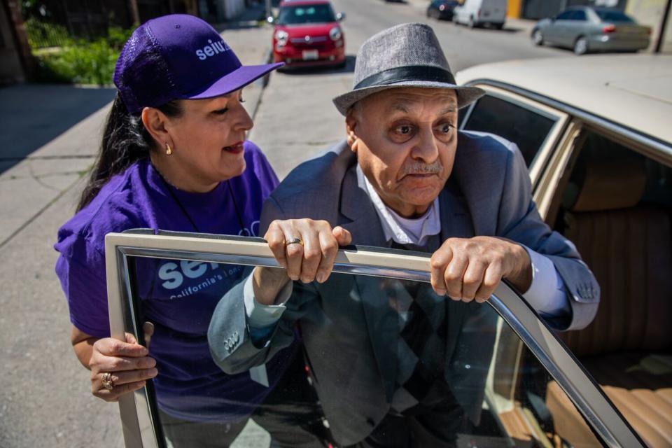 Patricia Santana helps Ismael Anguiano to get into a car