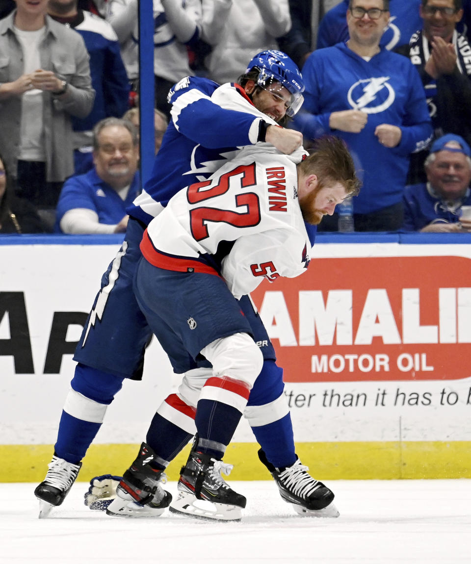 Tampa Bay Lightning left wing Pat Maroon and Washington Capitals defenseman Matt Irwin (52) fight during the first period of an NHL hockey game, Sunday, Nov. 13, 2022, in Tampa, Fla. (AP Photo/Jason Behnken)