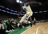 Golden State Warriors forward Draymond Green (23) jumps to save the ball from going out of bounds in front of the Boston Celtics bench in the first quarter of an NBA basketball game, Saturday, Jan. 26, 2019, in Boston. (AP Photo/Elise Amendola)