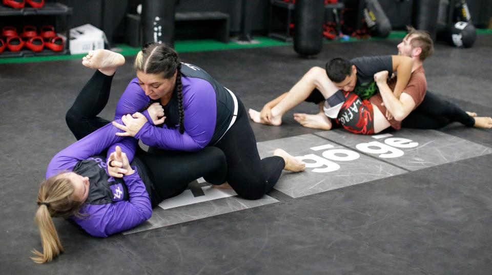 Maggie Wickenhauser, left, wrestles with Jenn Kozlowski, during a Jiu Jitsu class, Monday, November 13, 2023, in Sheboygan, Wis.