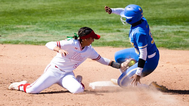 Utah infielder Aliya Belarde (23) attempts to tag out a sliding UCLA outfielder Lauren Hatch (30) during an NCAA softball game between Utah and UCLA at Dumke Family Softball Stadium in Salt Lake City on April 29, 2023.