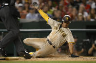 San Diego Padres' Juan Sotoslide scores on a double by Manny Machado during the fifth inning of the team's baseball game against the Washington Nationals, Friday, Aug. 12, 2022, in Washington. (AP Photo/Nick Wass)