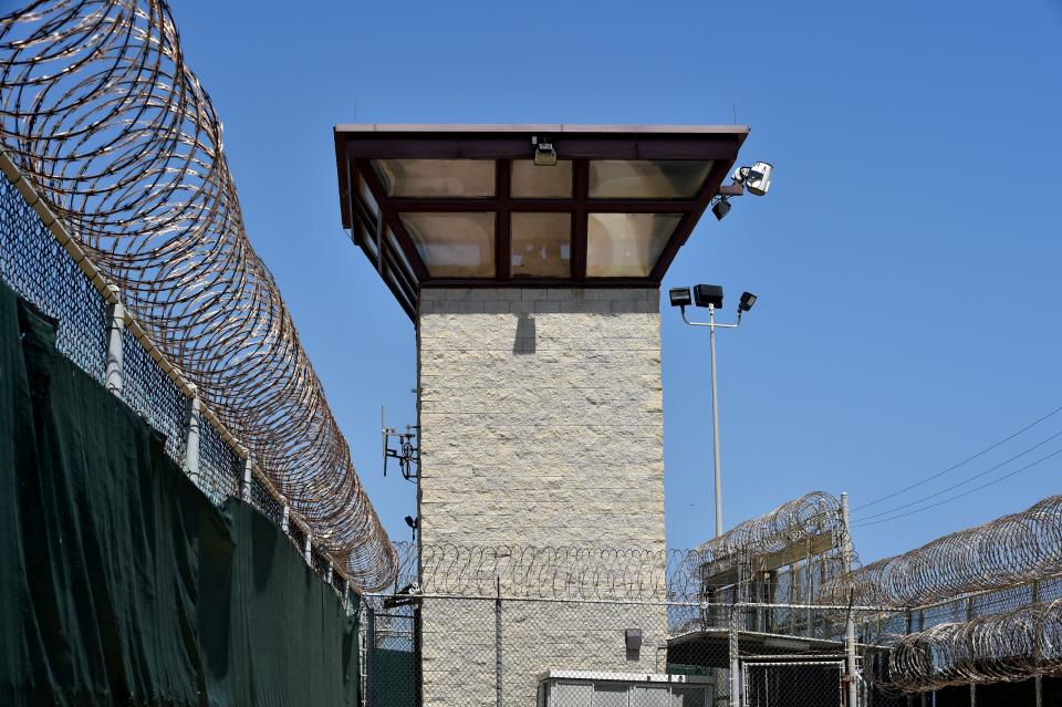 Fences topped with razor wire and a watch tower mark&nbsp;the Guantanamo prison camp. (Photo: MLADEN ANTONOV/AFP/Getty Images)