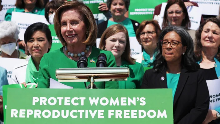 Speaker of the House Nancy Pelosi stands at a podium at an event on protecting women’s reproductive freedom.