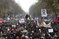 People attend a demonstration in Paris, Thursday, Dec. 5, 2019. The Eiffel Tower shut down, France's vaunted high-speed trains stood still and several thousand protesters marched through Paris as unions launched open-ended, nationwide strikes Thursday over the government's plan to overhaul the retirement system. (AP Photo/Thibault Camus)