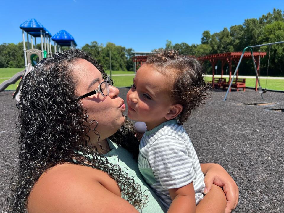 Tatiana Reams kisses her son Oliver Reams, 2, while visiting the playground at Bryant Commons park in Hinesville on Sunday August 14, 2022.