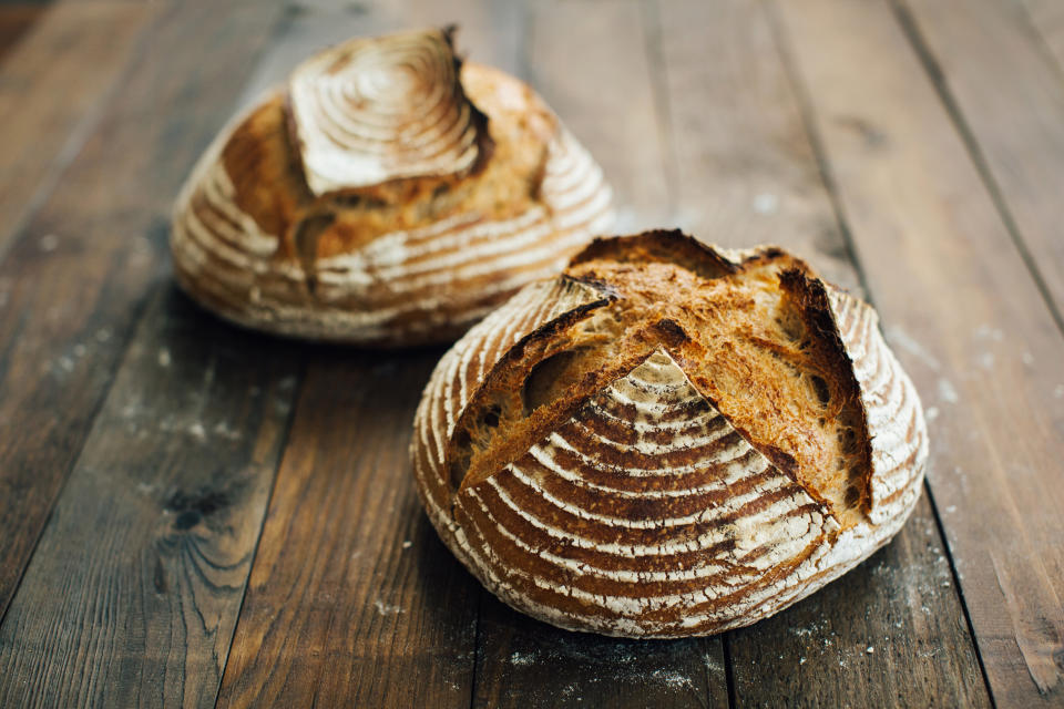 homemade artisan bread on vintage wooden background.