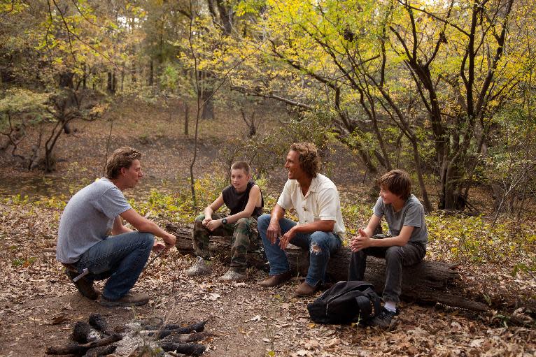 This film publicity image released by Roadside Attractions shows director Jeff Nichols, from left, with actors, Tye Sheridan, Matthew Mc Conaughey and Jacob Lofland on the set of "mud." Nichols fashions a Mark Twain-esque Mississippi River tale with some big Hollywood names, including Matthew Mc Conaughey and Reese Witherspoon. (AP Photo/Roadside Attractions, Jim Bridges)