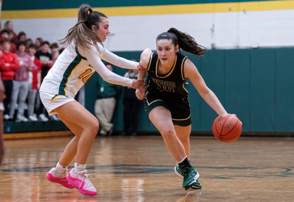 Lansdale Catholic's Nadia Yemola (10) against Archbishop Wood's Emily Knouse (30) during their girls' basketball game in Lansdale on Tuesday, Jan. 23, 2024.

Daniella Heminghaus | Bucks County Courier Times