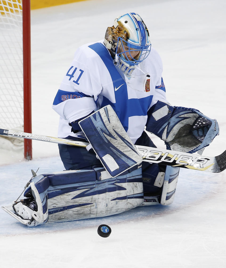 Goalkeeper Noora Raty of Finland blocks a shot on goal during the 2014 Winter Olympics women's ice hockey game against Germany at Shayba Arena, Sunday, Feb. 16, 2014, in Sochi, Russia. (AP Photo/Petr David Josek)