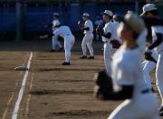 Members of Fukushima Commercial High School baseball team take part in a workout at the school's baseball field in Fukushima, Japan