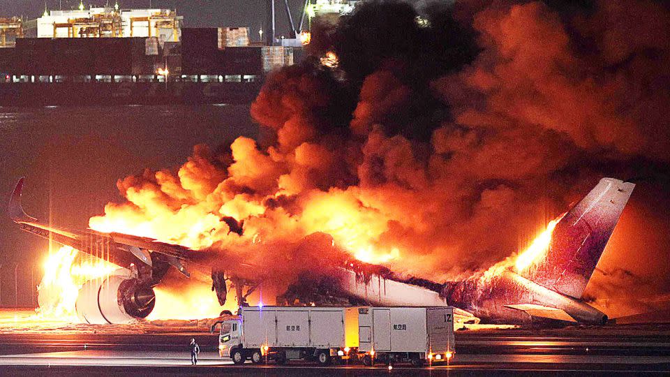 The Japan Airlines plane is gutted by fire on a runway of Tokyo's Haneda Airport on January 2, 2024. - STR/JIJI PRESS/AFP/Getty Images